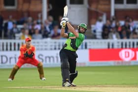 Brave batsman Ross Whiteley hits out watched by Phoenix keeper Chris Benjamin. Photo by Stu Forster/Getty Images.
