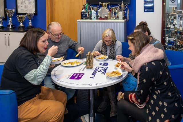 Enjoying the free, fresh meal served at the Winter Warmer event. Picture: Mike Cooter (101222)