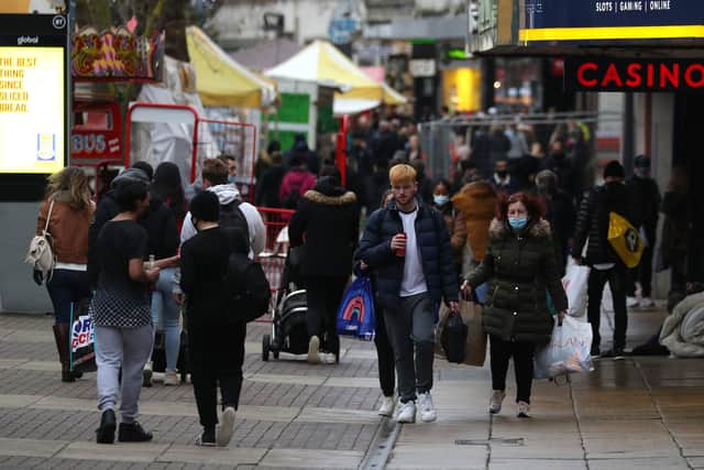 People make their way along Commercial Road in Portsmouth. Picture: Andrew Matthews/PA Wire