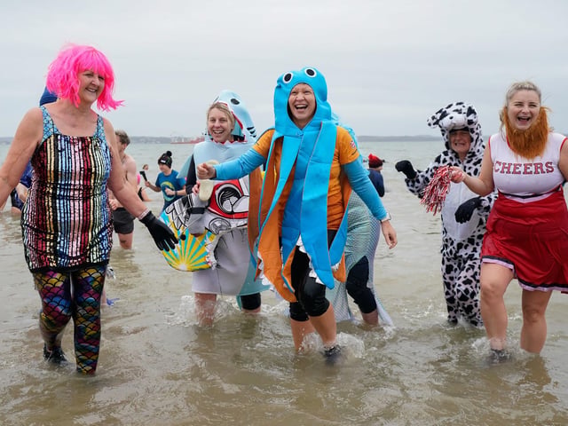 People take part in the Gosport New Year's Day Dip in The Solent at Stokes Bay, Gosport, Hampshire, to raise money for Gosport and Fareham Inshore Rescue Service.