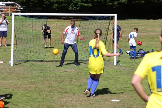 Pictured is Chris Kamara with some of the Hawks Community Youth FC team. Picture: Sam Stephenson.