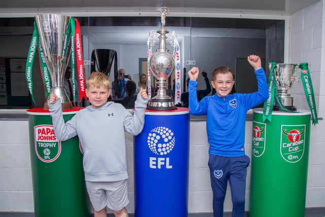 Max Frowen 8 and his brother Billy 12 next to a few EFL trophies at Bay House School, Gosport.