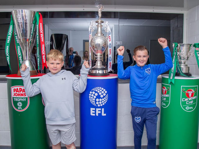 Max Frowen 8 and his brother Billy 12 next to a few EFL trophies at Bay House School, Gosport.
