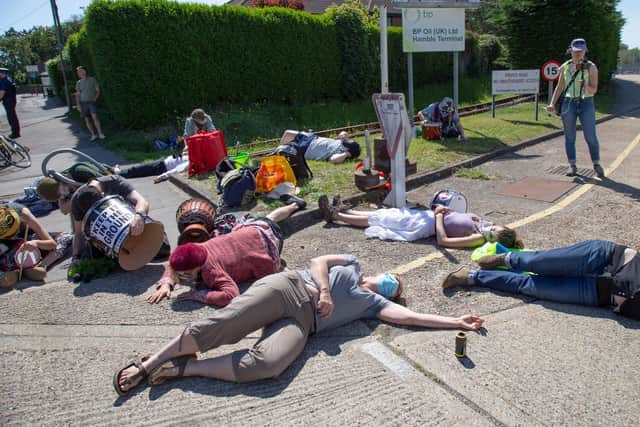 Handout photo issued by Extinction Rebellion of activists locking down BP's Southampton oil terminal highlighting Government and fossil fuel industry "greenwash" policies. Issue date: Tuesday June 1, 2021. PA Photo: William Templeton/PA Wire