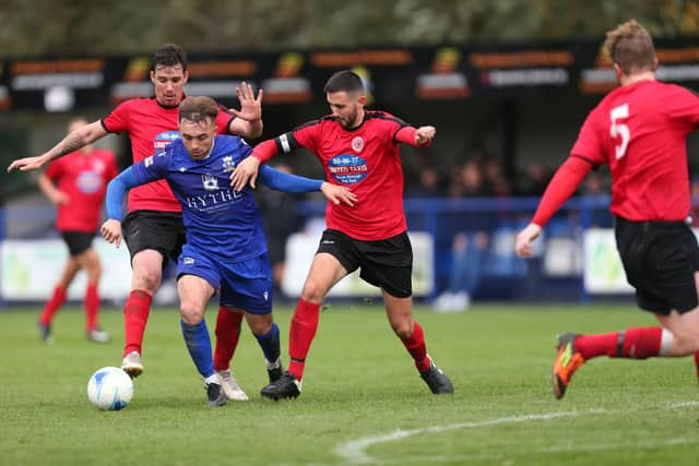 Billy Connor takes on two Bournemouth Poppies defenders. Picture: Chris Moorhouse