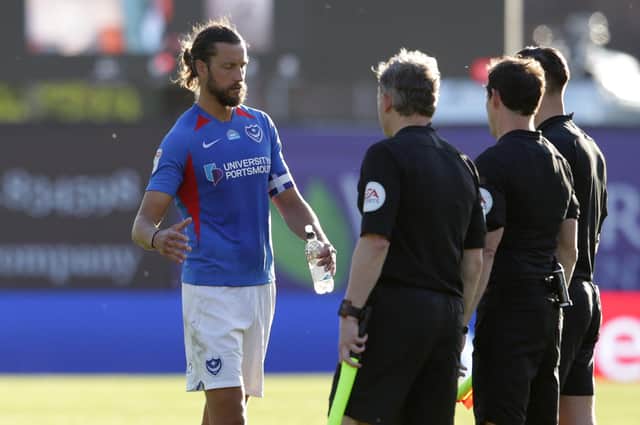 Christian Burgesss shakes hands with the match officials after his final Pompey game against Oxford. Picture: Robin Jones/Getty Images