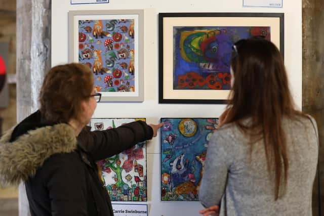 The Wilder Art Exhibition, hosted by Hampshire & Isle of Wight Wildlife Trust, is taking place on October 9 and 10 in the Round Tower, Southsea.

Pictured are members of the public viewing the art.

Picture: Sam Stephenson