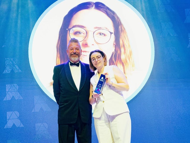 Entrepreneur of the Year, Jodie Goodchild, celebrates on stage with the business awards host Mark Collins  Picture: Keith Woodland (270321-218)