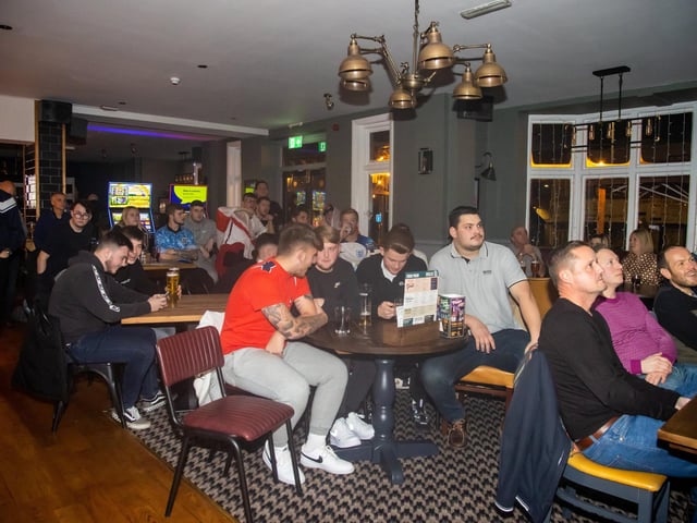 England fans watching on anxiously as England begin their game against Senegal. Photos by Alex Shute