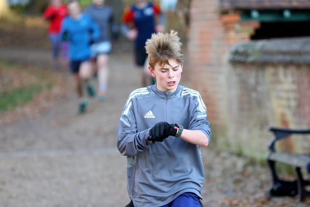 Thomas Savill, 13, checks his time as he crosses the line at Havant Parkrun, Staunton Country Park