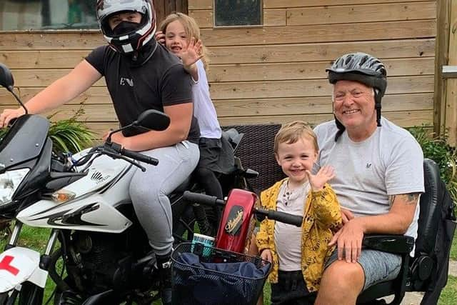 Mark Jones pictured with his three oldest  grandchildren, Jamie, 18, left, Esme, five, and William, three.