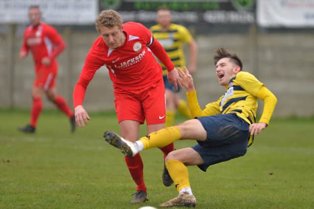 Ash Howes (Horndean, red) in action during his side's home loss to Hamworthy earlier this season. The return fixture takes place in Dorset this Saturday. Picture: Martyn White