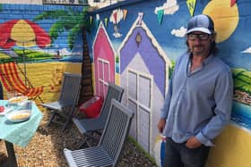 Southsea resident Mark Lewis with his latest mural. Picture: Richard Lemmer