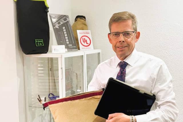 IN THE BAG: Barnbrook managing director Andrew Barnett with the company's E:BAG for putting our lithium-ion battery fires in such devices as mobile phones and tablets