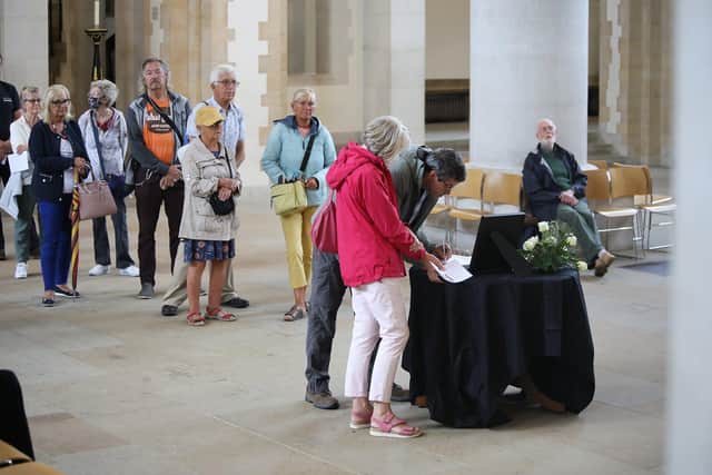 Queues form to sign the book of condolence in Portsmouth Cathedral on Friday