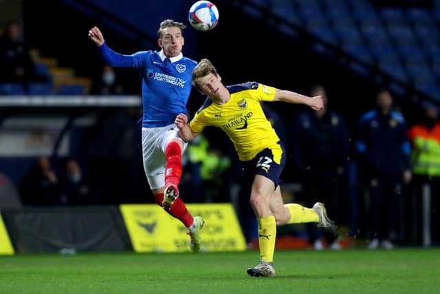 Ronan Curtis challenges Robert Atkinson after being handed striking duties in last night's 1-0 win at Oxford United. Picture: David Davies/PA Wire.