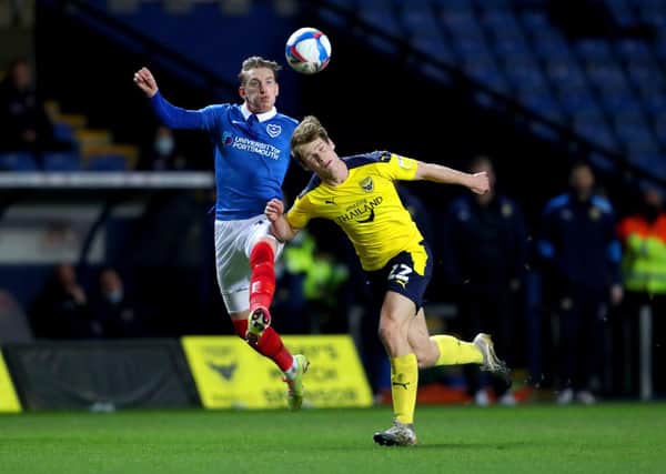 Ronan Curtis challenges Robert Atkinson after being handed striking duties in last night's 1-0 win at Oxford United. Picture: David Davies/PA Wire.