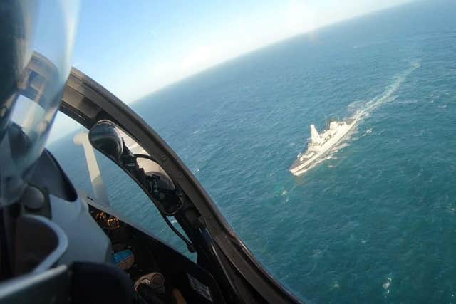 HMS Dragon pictured from above as a fighter pilot launches a mock attack on the Type 45 destroyer. Photo: Royal Navy