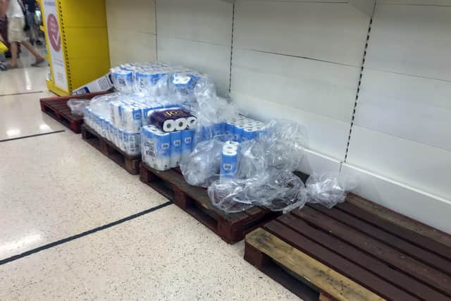 Depleted stocks and empty pallets in the toilet roll aisle at the Portsmouth North Harbour Tesco. Picture: PA wire/Steve Parsons
