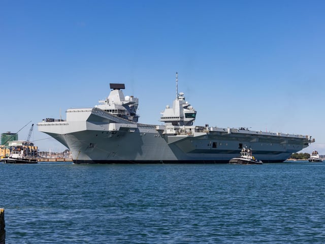 HMS Prince Of Wales being towed out of Portsmouth Harbour. Picture: Mike Cooter (280924)