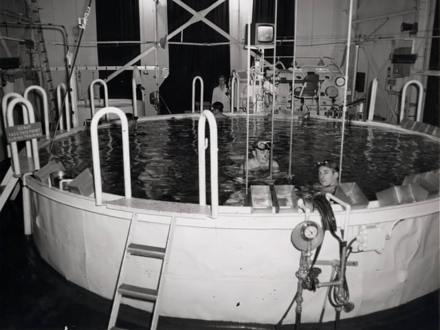 Servicemen in a submarine escape training tank at HMS Dolphin, Fort Blockhouse, Haslar Road, Gosport. This is where all submariners had to learn to escape through 100 feet of water.Credit - National Museum of the Royal Navy