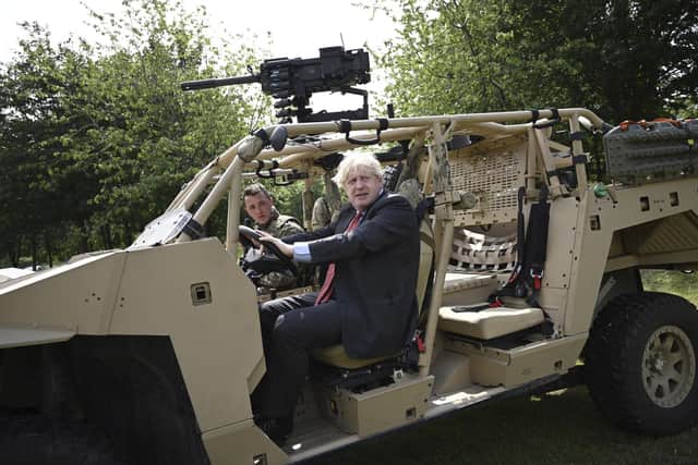 Britain's Prime Minister Boris Johnson poses in an armoured vehicle of the new Ranger Regiment during a visit to mark Armed Forces Week, at the Aldershot Garrison in Aldershot, England. Picture: Daniel Leal-Olivas/Pool via PA.
