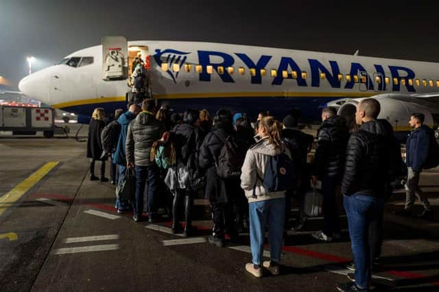 A picture taken on January 18 2020 shows passengers waiting to board an aircraft of low cost Irish airline Ryanair (Photo: JOHN MACDOUGALL/AFP via Getty Images)