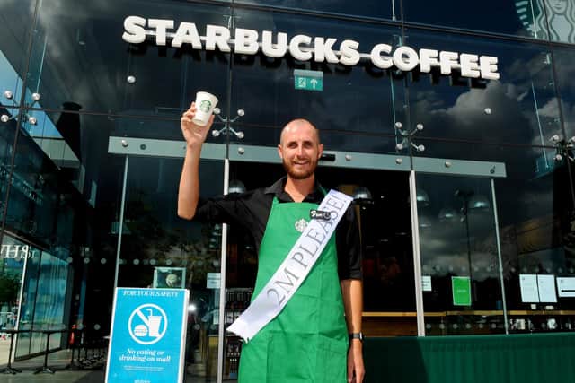 Shops in Whiteley Shopping Centre reopened on Monday, June 15, with safety measures in place under the most recent guidelines during the Covid-19 pandemic.Pictured is: Starbucks barista Dom Court welcomes back customers to Starbucks in Whiteley Shopping Centre, who were the first coffee shop to open at the site for takeaway services.Picture: Sarah Standing (160620-46)