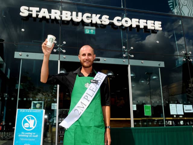 Shops in Whiteley Shopping Centre reopened on Monday, June 15, with safety measures in place under the most recent guidelines during the Covid-19 pandemic.

Pictured is: Starbucks barista Dom Court welcomes back customers to Starbucks in Whiteley Shopping Centre, who were the first coffee shop to open at the site for takeaway services.

Picture: Sarah Standing (160620-46)