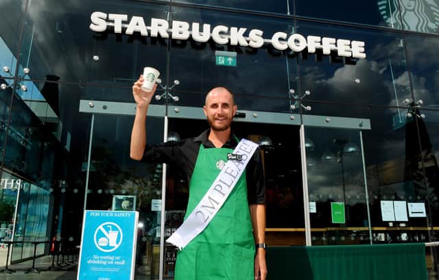 Shops in Whiteley Shopping Centre reopened on Monday, June 15, with safety measures in place under the most recent guidelines during the Covid-19 pandemic.Pictured is: Starbucks barista Dom Court welcomes back customers to Starbucks in Whiteley Shopping Centre, who were the first coffee shop to open at the site for takeaway services.Picture: Sarah Standing (160620-46)