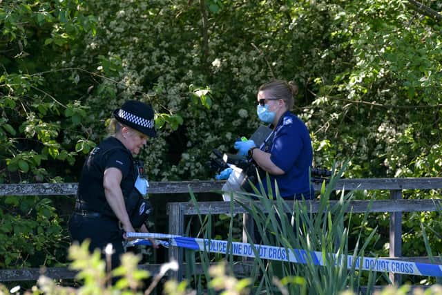 A forensic officer at the scene at Swanwick Lake, Hants as a body was found in the water last night. Picture: Solent News & Photo Agency