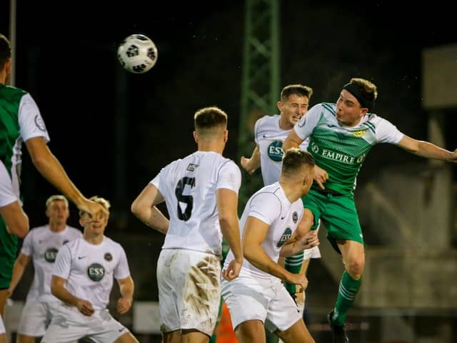 Tom Cain heads home Moneyfields' equaliser in last night's Portsmouth Senior Cup win over the Royal Navy Under-23s. Picture by Dave Bodymore.
