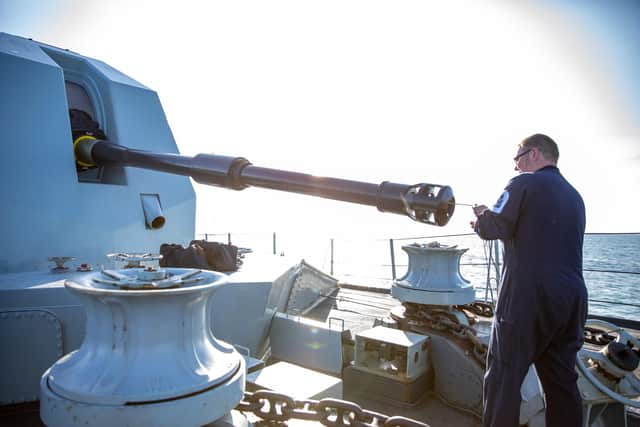 HMS Lancaster maintainers ensuring the barrel is clear prior to firing the 4.5in gun. Photo: PO Phot Carl Osmond