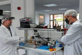 Engineers working on the satellite at In-Space