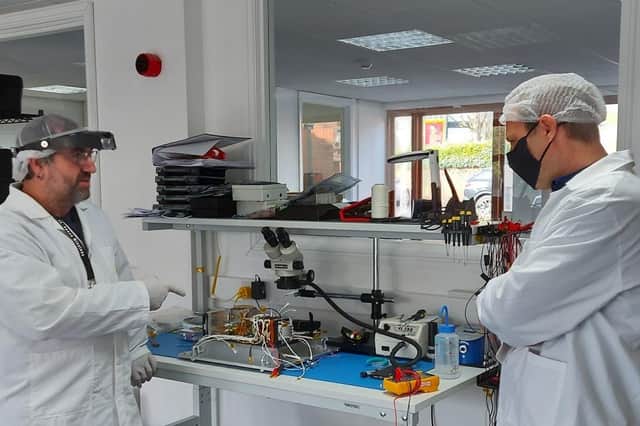 Engineers working on the satellite at In-Space