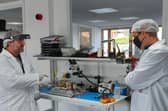 Engineers working on the satellite at In-Space