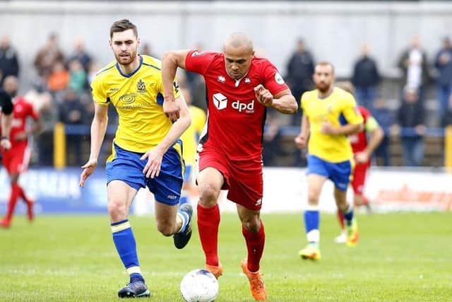 Dartford's Elliott Romain (red) has scored 16 league goals this season. Picture by Lydia Redman