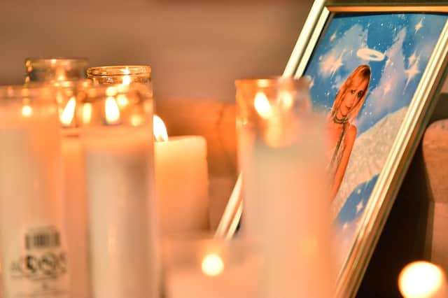 Candles are placed in front of a photo of cinematographer Halyna Hutchins during a vigil in her honor at Albuquerque Civic Plaza on October 23, 2021 in Albuquerque, New Mexico. Hutchins was killed on set while filming the movie "Rust" at Bonanza Creek Ranch near Santa Fe, New Mexico on October 21, 2021. Photo by Sam Wasson/Getty Images)