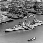The Royal Navy Town-class light cruiser HMS Belfast under tow from tugboats passes the18th century 104-gun first-rate ship of the line and Admiral Lord Nelson's flagship HMS Victory on her last voyage from Portsmouth Dockyard to her new berth in London as a floating museum on 2 September 1971 in Portsmouth, United Kingdom.  (Photo by Keystone/Hulton Archive/Getty Images).