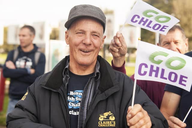 A fan cheers on runners during the Great South Run 5km on Saturday. Photo: David Tiller