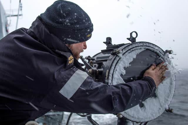 Pictured: AB(Sea Specialist) Sam Siddell clears snow from a communications lamp after a heavy snow squall in the Baltic Region.

Credit: LPhot Dan Rosenbaum, HMS Lancaster