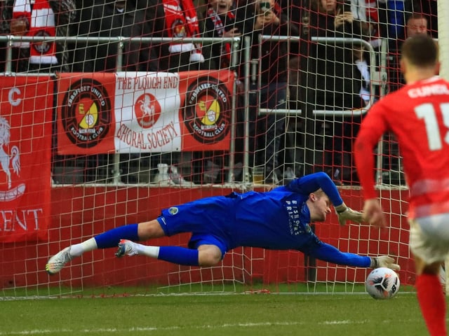 Hawks loanee keeper Teddy Sharman-Lowe saves Rakish Bingham's spot-kick. Picture by Dave Haines