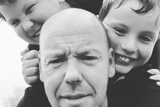 Loving dad Andrew Blomfield, centre, has been left with a fractured skull. He is pictured with his sons Beau, left, Callum, top centre, and Dexter, right