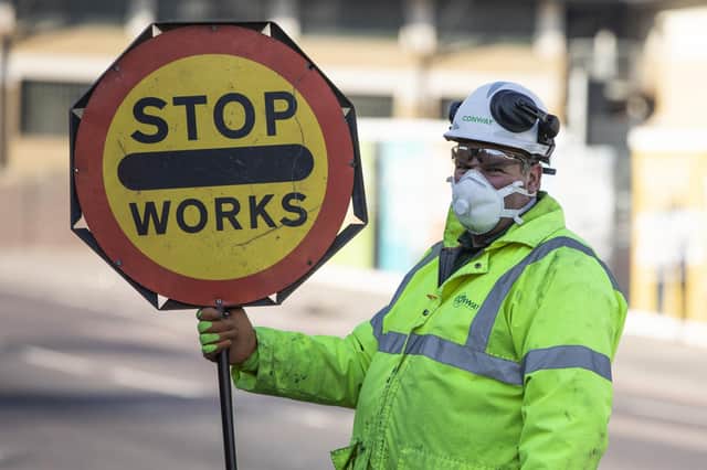 Businesses in Hampshire are being thrown a lifeline by the Solent LEP to help them survive the Coronavirus crisis. Pictured is a construction worker wearing masks. Photo by Dan Kitwood/Getty Images