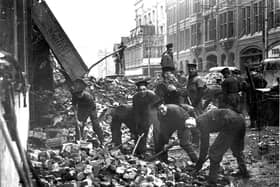 Sailors clearing debris from the remains of the Hippodrome, Commercial Road (it's the one with 'Twice Nightly' in the background).