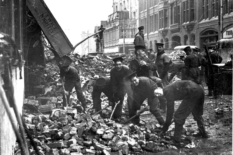 Sailors clearing debris from the remains of the Hippodrome, Commercial Road (it's the one with 'Twice Nightly' in the background).