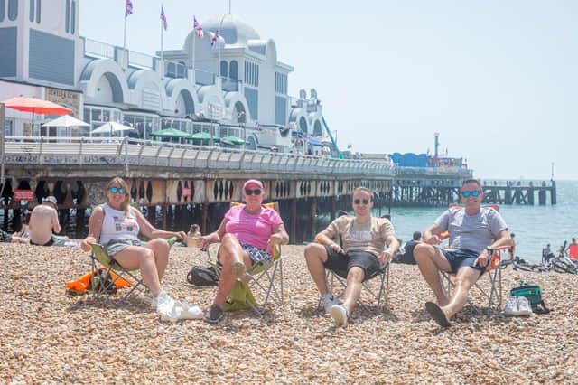 Lyndsey Jardine, Anne Woolley, Jack Woolley and Steve Maynard soaking in the sun near South Parade pier.