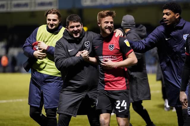 Michael Jacobs celebrates with Pompey staff and team-mates following his last-gasp Gillingham winner. Picture: Jason Brown/ProSportsImages