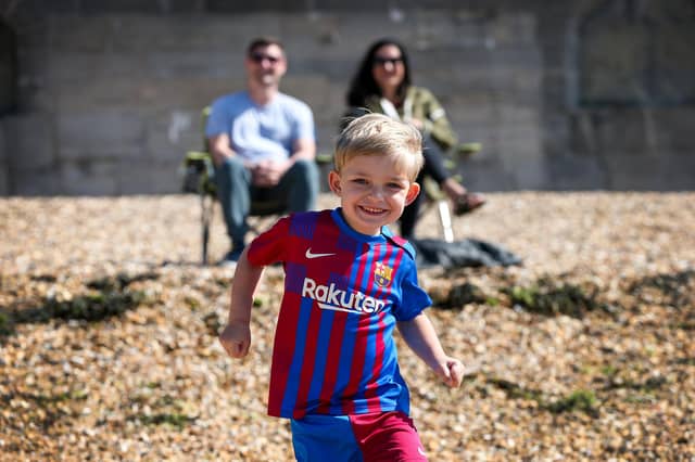 Thomas Clegg, 4, with his parents Richard and Mellony Clegg on a sunny Saturday morning in Old Portsmouth. Picture: Chris Moorhouse (250524-06)