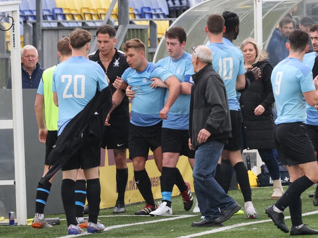 An injured Wicor Mill player is helped off. Picture by Kevin Shipp